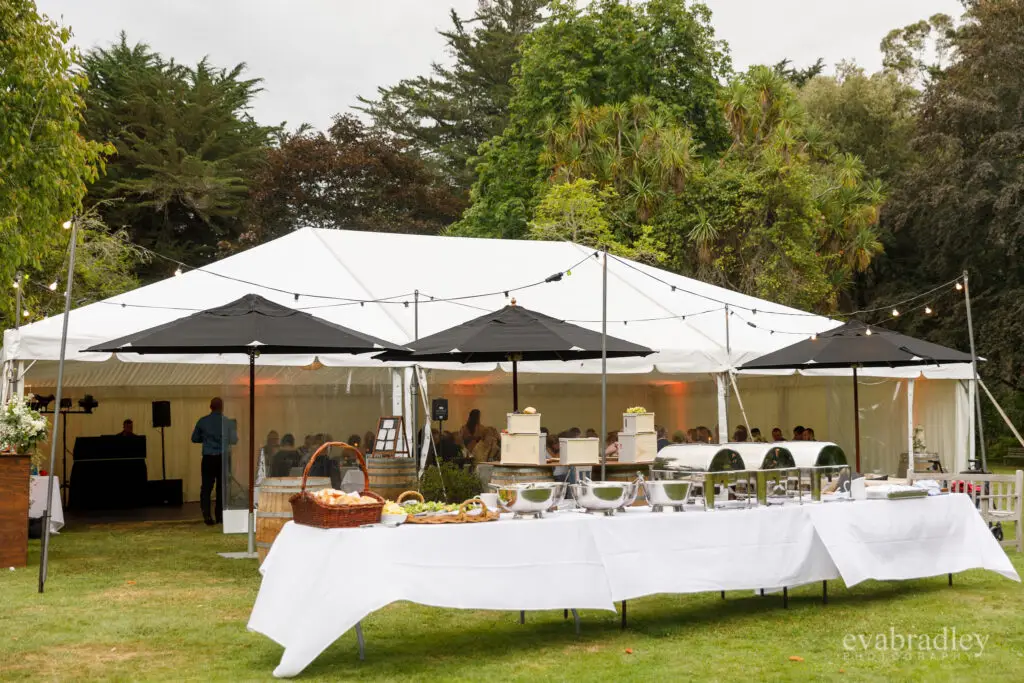 Marquee reception tent decorated with string lights for a wedding
