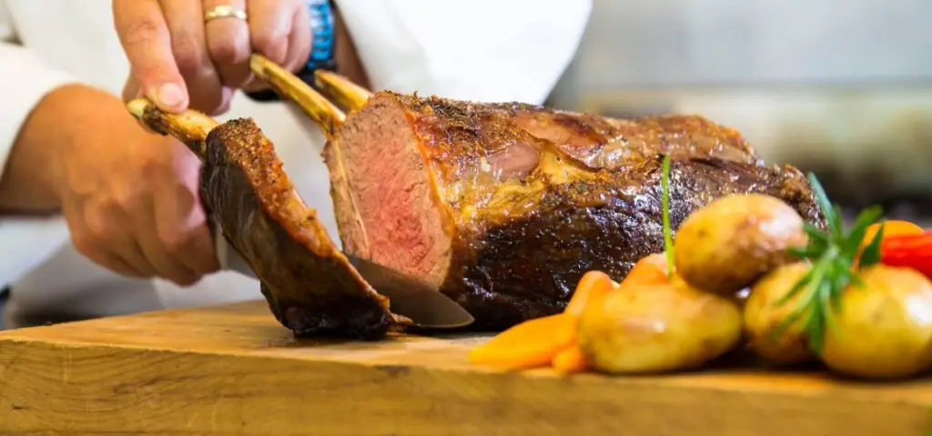 Chef carving roasted meat with vegetables for Hawke's Bay event catering